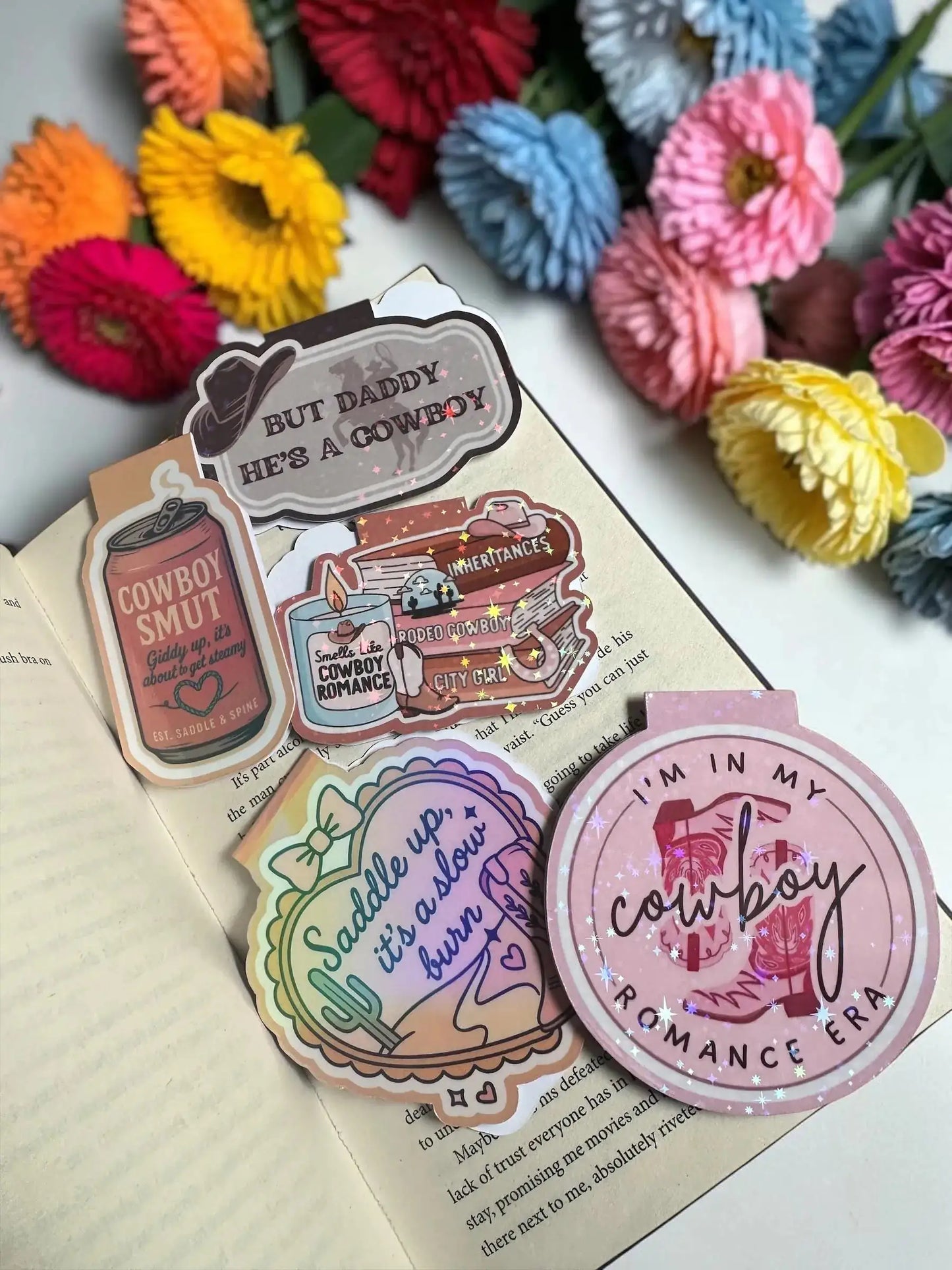 Collection of cowboy romance holographic magnetic bookmarks including Smells Like Cowboy Romance, Cowboy Smut, and more by Enchanted Bookcase