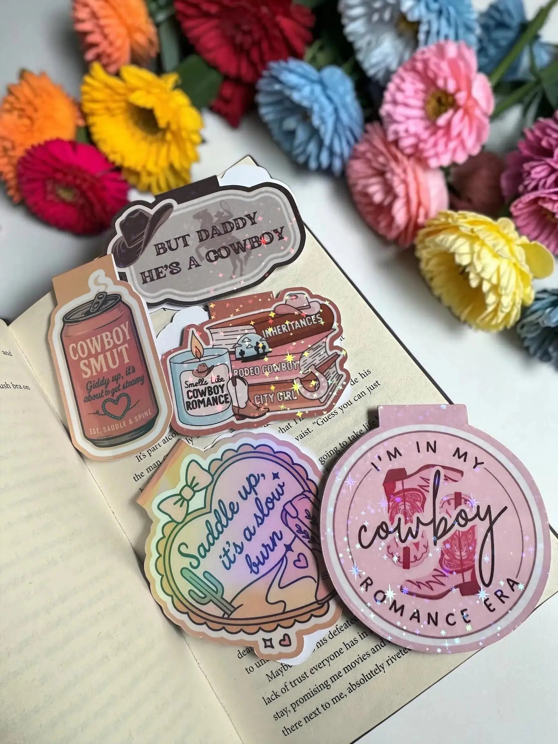 Collection of cowboy romance holographic magnetic bookmarks including Smells Like Cowboy Romance, Cowboy Smut, and more by Enchanted Bookcase