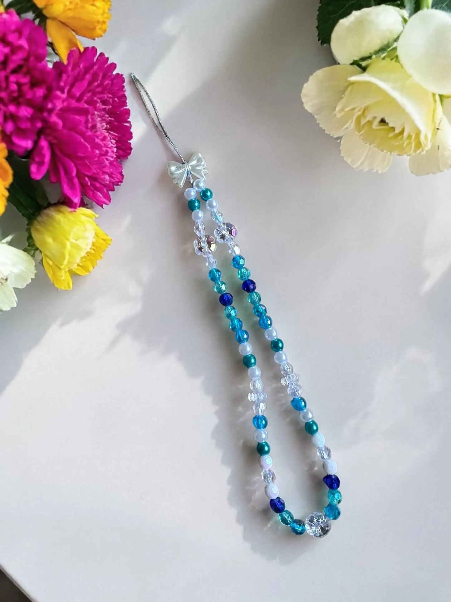 Ocean Breeze handmade beaded phone chain with blue turquoise crystals and white bow by Enchanted Bookcase